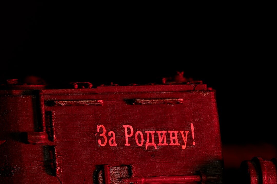 Radio station on-air sign glowing red in a dark studio