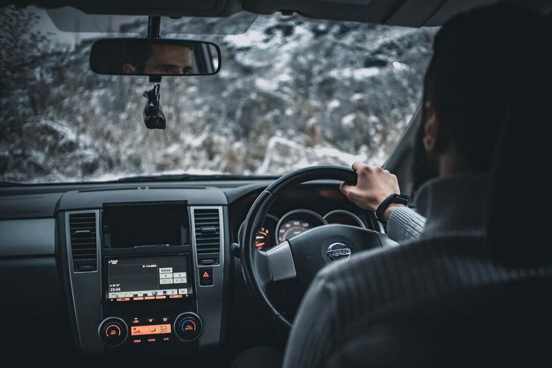 person tuning radio in car